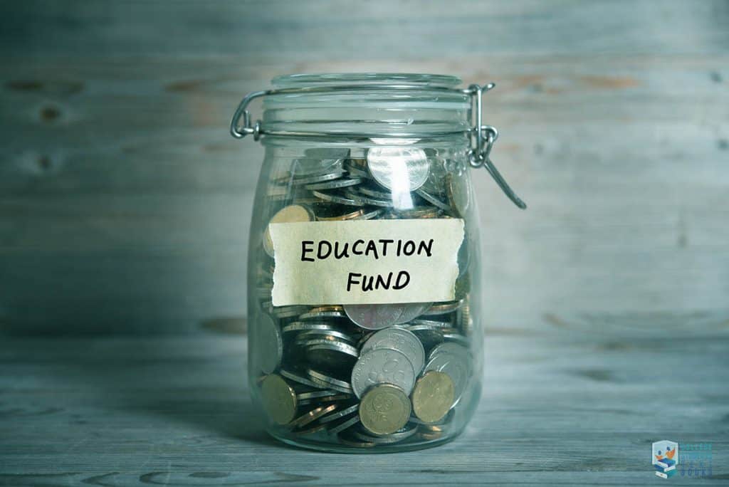 Education fund - reduce your expenses

Image shows a glass jar with education fund label filled with coins. Vintage wooden background with dramatic cyan light.